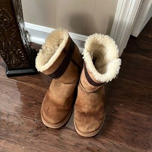 Ugg boots with leather bow around them